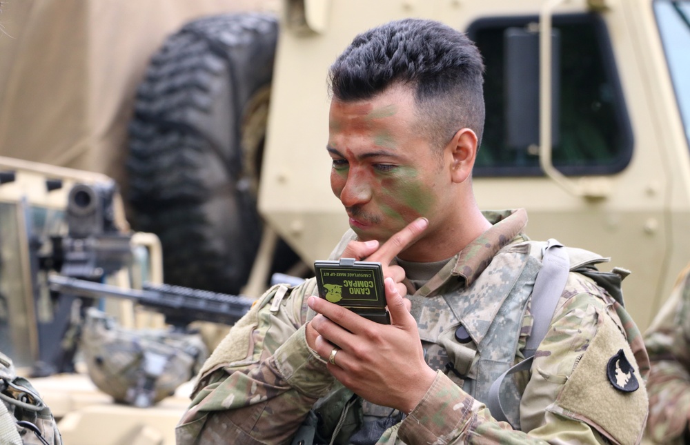 IANG Infantry Soldier Applies Face Paint at XCTC