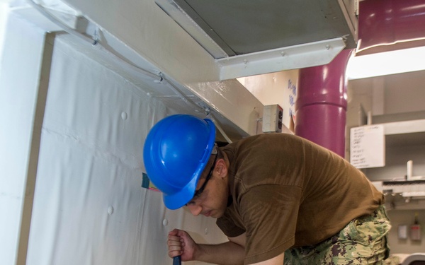 GHWB Sailor Removes Deck Material