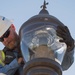 Electricians repair street lamp
