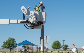 Electricians repair street lamp