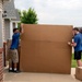 Movers pack personal property into crates