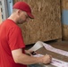 Movers pack personal property into crates