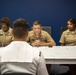 Sailors stand Sailor of the Quarter board at Navy Recruiting District Philadelphia.