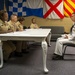 Sailors stand Sailor of the Quarter board at Navy Recruiting District Philadelphia.