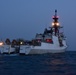 CGC Bertholf prepares to recover small boat as dusk falls in the East China Sea