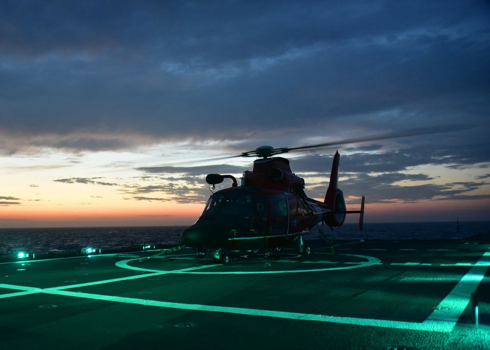 Sun sets during flight ops aboard CGC Bertholf in the Yellow Sea