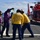 Crewmembers check fuel during "hot gas" operations aboard CGC Bertholf