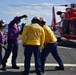 Crewmembers check fuel during &quot;hot gas&quot; operations aboard CGC Bertholf