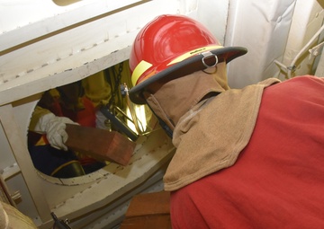 CGC Bertholf crew train for damage control during Western Pacific patrol