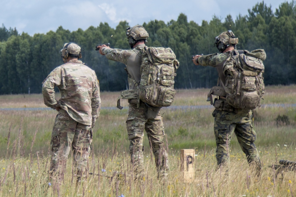 A Czech sniper and spotter engage targets with pistols.