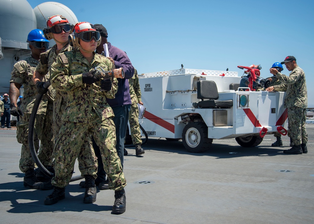 MAKIN ISLAND AIR DEPARTMENT SAILORS CONDUCT CRASH AND SALVAGE DRILL.