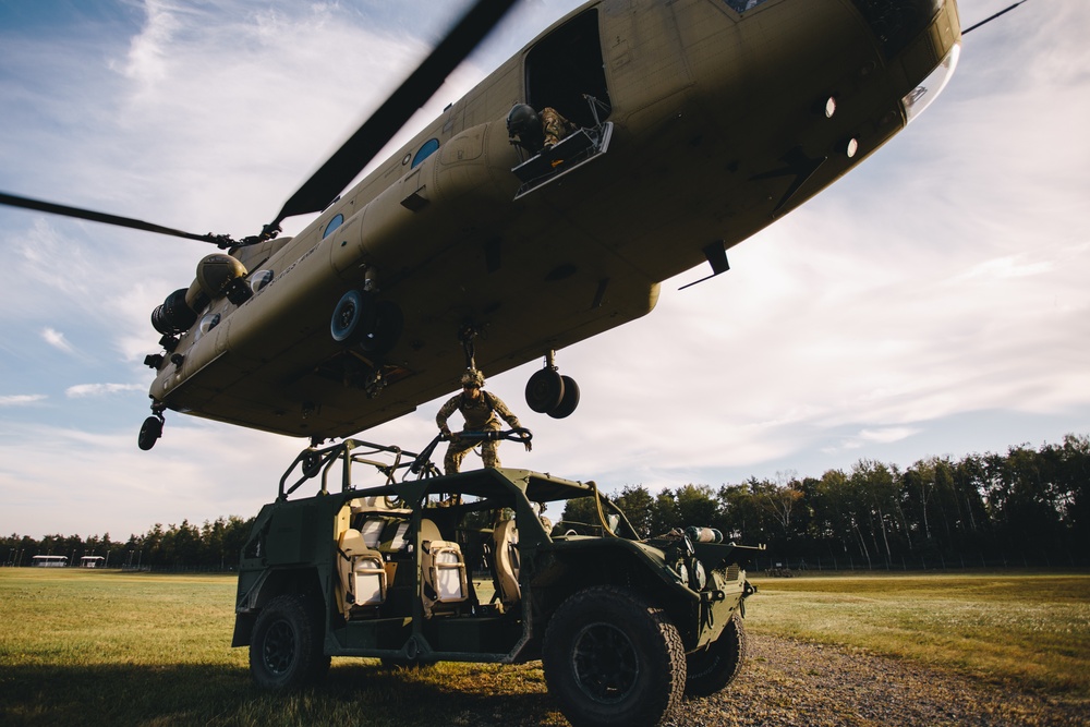 U.S. Army paratroopers sling load a Ground Mobility Vehicle