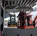 U.S.  Sailors perform maintenance on the side of the aircraft carrier USS John C. Stennis (CVN 74)