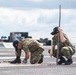 U.S. Sailor tightens bolts on a jet blast deflector