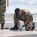 U.S. Sailor tightens bolts on a jet blast deflector