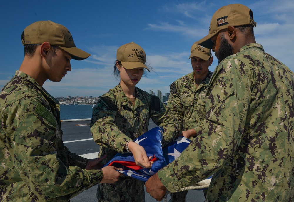 Nimitz Sailors Fold Ensign During Port Visit to San Diego