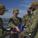 Nimitz Sailors Fold Ensign During Port Visit to San Diego