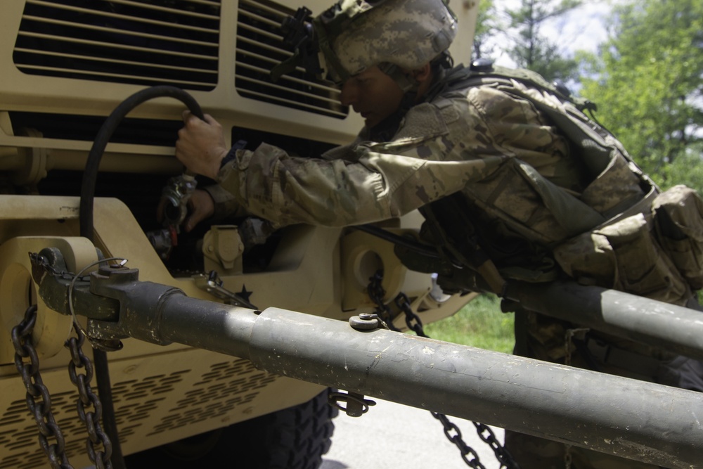 Soldier prepares to tow LMTV