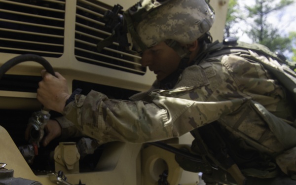 Soldier prepares to tow LMTV