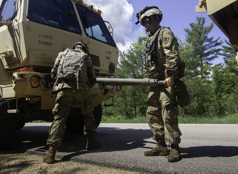 Soldiers prepare LMTV for towing