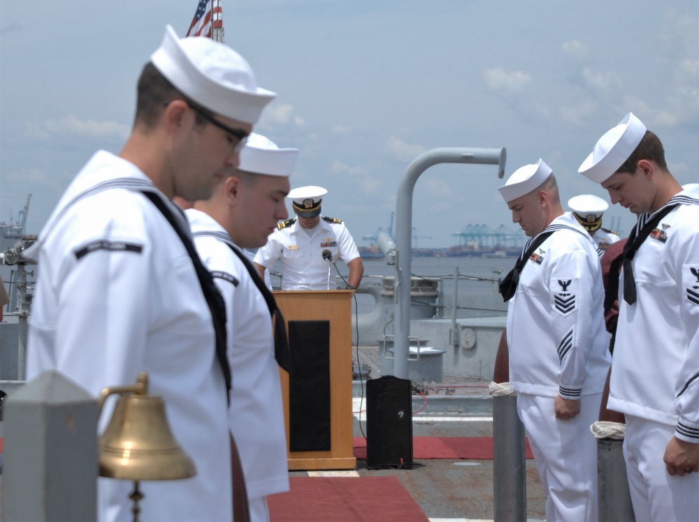 Sailors bow their heads during the Chaplain's invocation