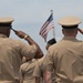 Saluting the National Ensign during a commissioning ceremony