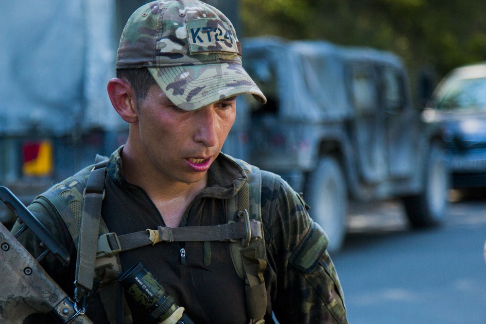 Cpl. Andres Nanez completes the ruck march for the European Best Sniper Competition, Grafenwoehr, Germany, July 25, 2019.