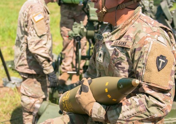 Student cannoneer carries projectile during culminating LFX