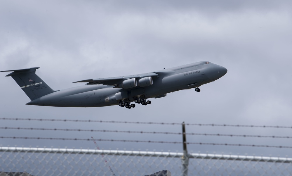 C-5C transports satellite piece