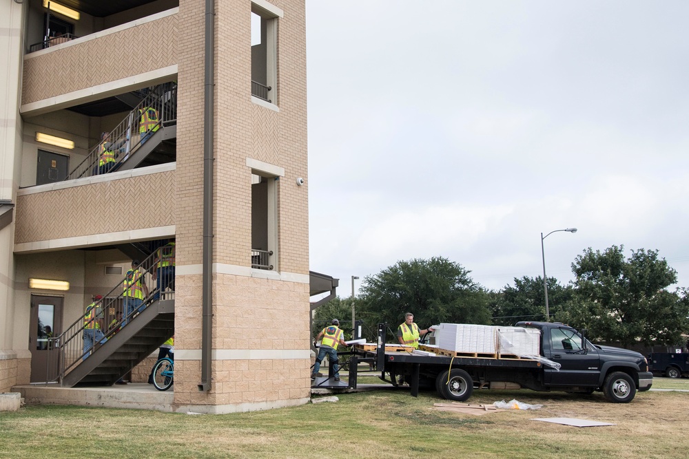 Professionals from the 502d Air Base Wing Civil Engineer Group work to remediate dorms with mold