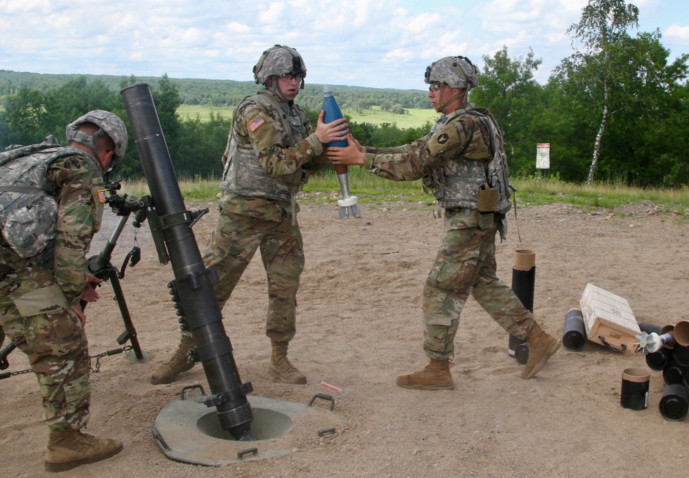 Infantryman Receives a 120mm Round From Ammo Bearer