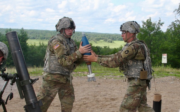 Infantryman Receives a 120mm Round From Ammo Bearer