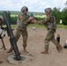 Infantryman Receives a 120mm Round From Ammo Bearer