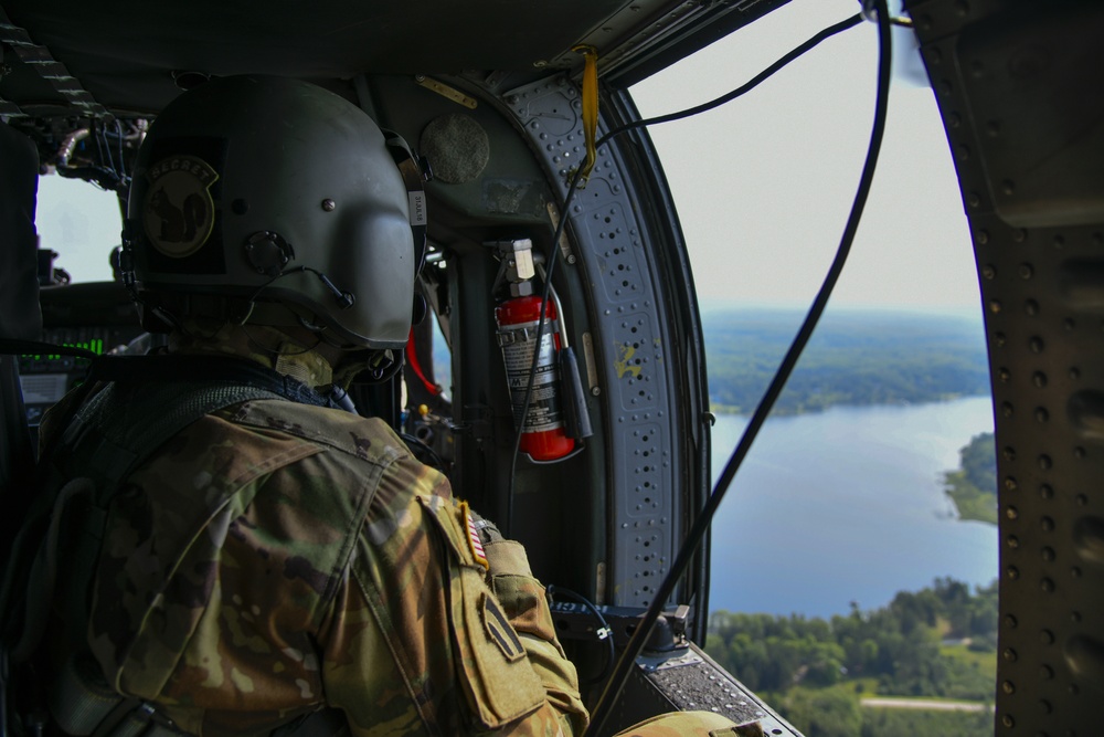 UH-60 Crew Chief looks out over one of Camp Grayling's surrounding lakes