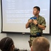 Aviation Ordnance Master Chief William Sullivan, the small arms trainer here at Officer Training Command, demonstrates safe weapons handling procedures to Officer Candidate School (OCS) class 15-19 candidates on July 30, 2019.