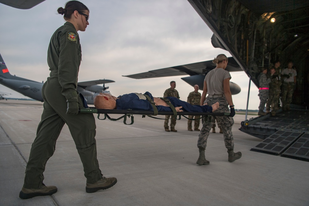 Teamwork loading patients on C-130 during Aeromedical Exercise at Northern Strike 19