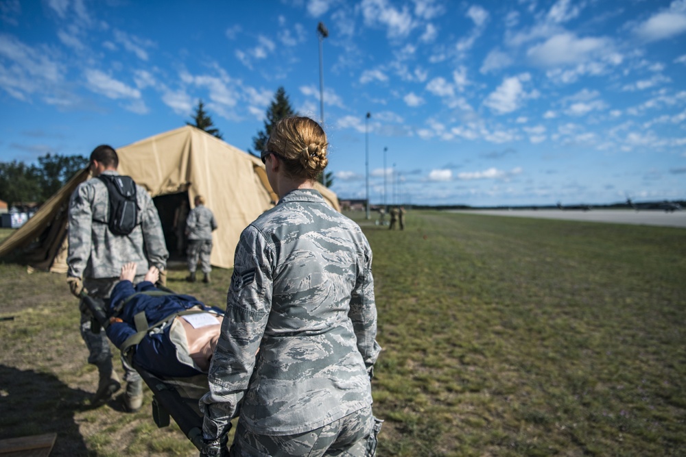 Moving a patient during Aeromedical Evacuation exercise at Northern Strike 19