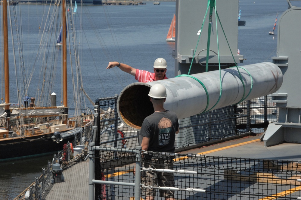 Battleship Wisconsin staff crane aboard empty missile tubes