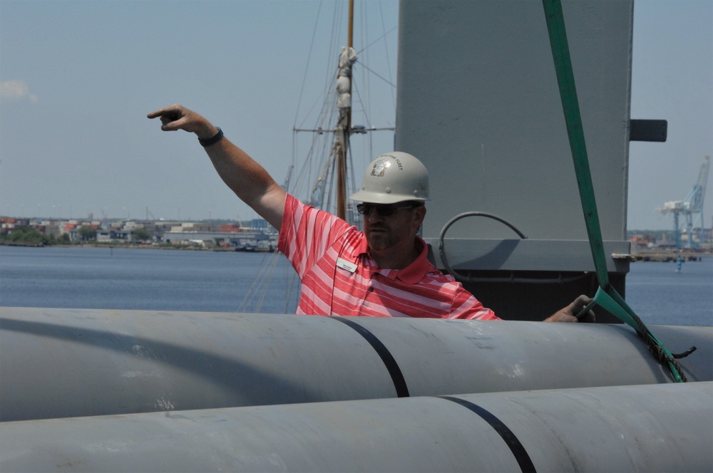 Battleship Wisconsin staff crane aboard empty missile tubes