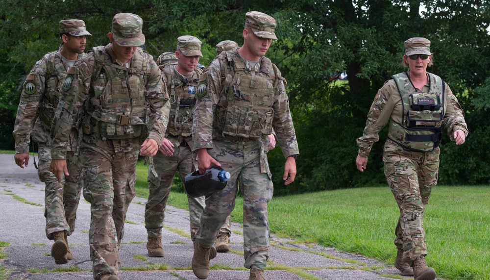 Chief Master Sgt. Katie McCool participates in a 3.5-mile ruck march with SF Airmen