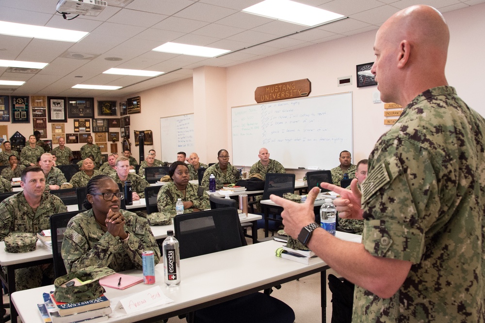 Capt. Mark A. Nicholson, commanding officer at Officer Training Command, Newport, Rhode Island (OTCN), shares a story about integrity to graduating class 19080 of the Limited Duty Officer/Chief Warrant Officer Academy (LDO/CWO) on Aug. 1, 2019.