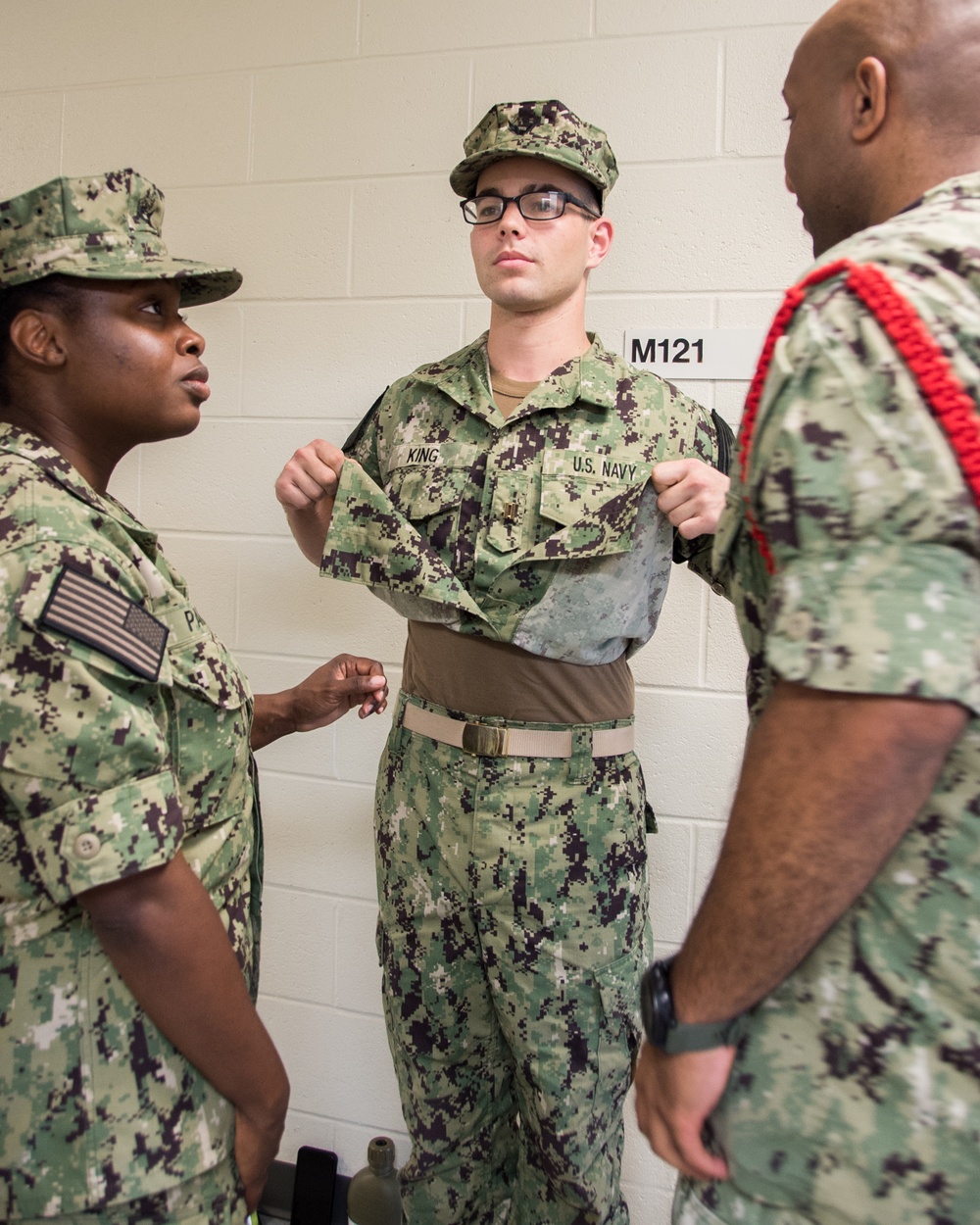 Electronics Technician Chief Jean F. Micourt trains Aviation Ordnanceman Chief LaChanda E. Parker how to properly conduct room, locker and personnel inspection (RLP) at Officer Candidate School (OCS) .