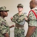 Electronics Technician Chief Jean F. Micourt trains Aviation Ordnanceman Chief LaChanda E. Parker how to properly conduct room, locker and personnel inspection (RLP) at Officer Candidate School (OCS) .