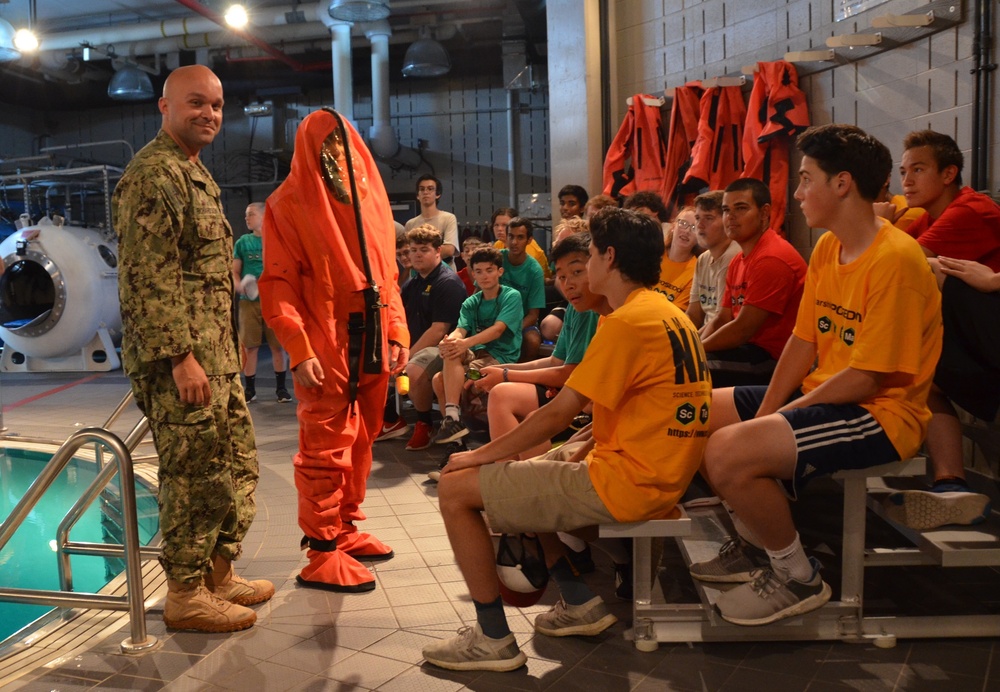 Navy Diver Demonstrates Survival Equipment to Starship Poseidon STEM