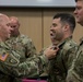 Col. Timothy Davis, 7th Army Training Command’s G3 pins the Army Achievement Medal (AAM) on  Maj. Erik Hamilton, the Exercise Control Center (EXCON) Battle Captain for the summer series of exercises