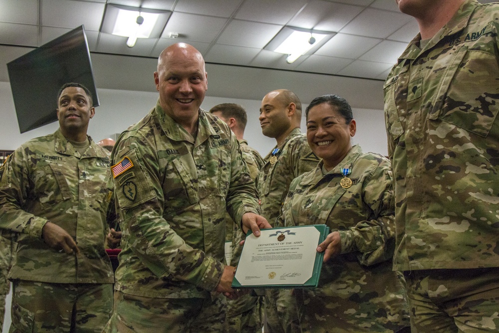 Col. Timothy Davis, 7th Army Training Command (ATC) G3  presents the Army Achievement medal (AAM) to  Master Sgt. Annalita Chavez-Pratt, 7th ATC Surgeon Cell Noncommissioned Officer in Charge