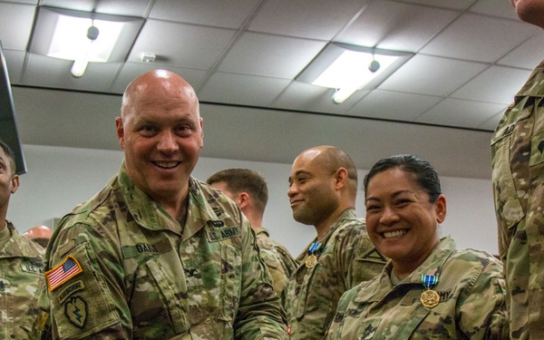 Col. Timothy Davis, 7th Army Training Command (ATC) G3  presents the Army Achievement medal (AAM) to  Master Sgt. Annalita Chavez-Pratt, 7th ATC Surgeon Cell Noncommissioned Officer in Charge