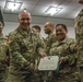 Col. Timothy Davis, 7th Army Training Command (ATC) G3  presents the Army Achievement medal (AAM) to  Master Sgt. Annalita Chavez-Pratt, 7th ATC Surgeon Cell Noncommissioned Officer in Charge