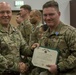 Col. Timothy Davis, 7th Army Training Command (ATC) G3  presents the Army Achievement medal (AAM) to  Spc. Christopher Addy, 7th ATC Communication Specialist