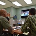 Students receive a de-brief during Sick Call Screeners Simulation Course